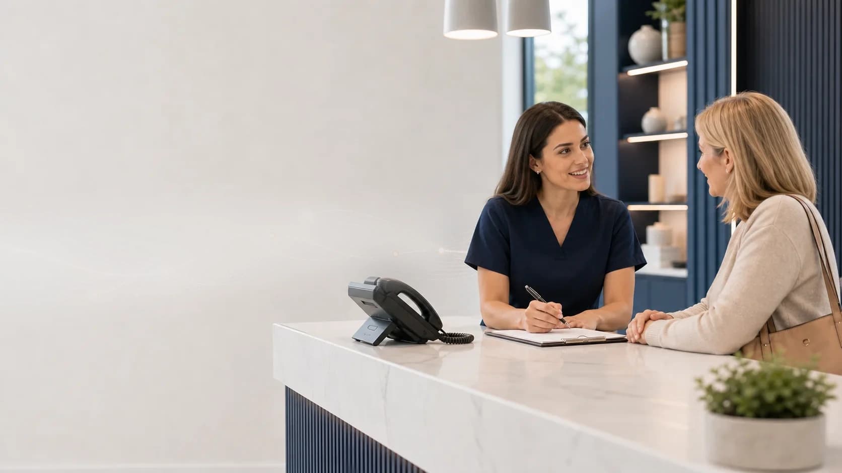 Dental reception team reviewing patient call coverage